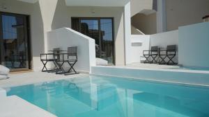 a house with a swimming pool with chairs around it at Diana Palace Hotel Zakynthos in Argassi