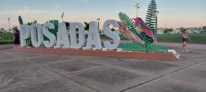 a sign for a park with people standing around it at Hotel Residencial Marlis in Posadas