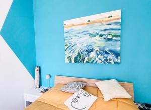 a bedroom with a bed with a painting on the wall at 1881 Artistic Royal House in Caserta