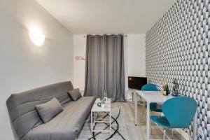 a living room with a couch and a table at 806 Suite Magic - Superb Apartment in Bagnolet