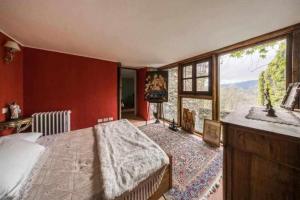 a bedroom with a bed and a large window at Torre del 1300 Un atto damore in Castiglione