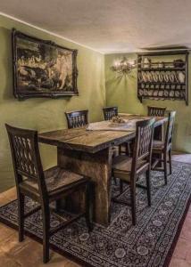 a dining room with a wooden table and chairs at Torre del 1300 Un atto damore in Castiglione