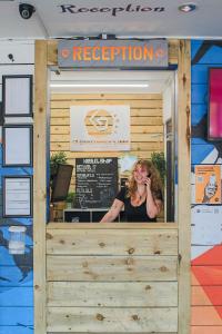 a woman talking on a cell phone in front of a restaurant at St Christopher's Inn Newquay in Newquay