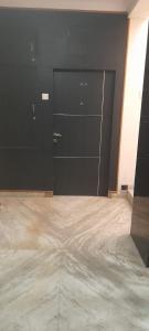 a room with two black doors and a bed at Al Amoodi Furnished Apartments in Hyderabad