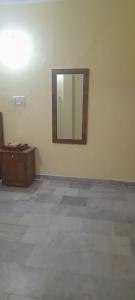 a mirror on a wall in a room at Al Amoodi Furnished Apartments in Hyderabad