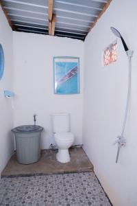 a bathroom with a toilet and a bath tub at Woywoy Paradise in Bira