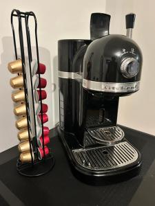 a black coffee maker sitting on top of a table at Villa Park in Bennebroek
