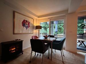 a dining room with a table and a fireplace at Villa Park in Bennebroek