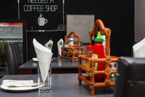 a table with a basket with condiments on it at Cedar Place in Blantyre