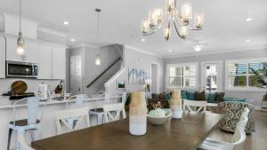 a kitchen and living room with a table and chairs at Sitting Bayside in Santa Rosa Beach