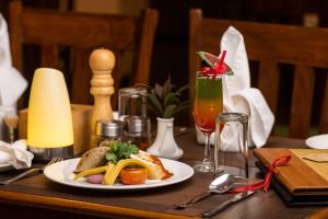 a table with a plate of food on a table at Dreamland Gold Resort & Hotel in Bhairāhawā