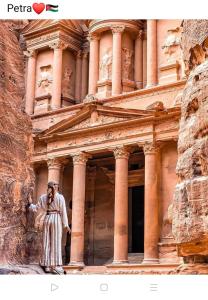 a man standing in front of a building at Petra Crystal hotel in Wadi Musa