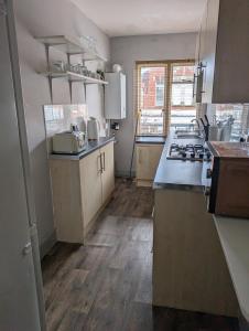 a kitchen with a sink and a stove at Twenty Four in Hythe