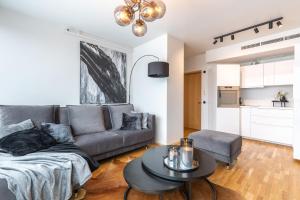 a living room with a couch and a table at Tallinn Tartumnt 84a in Tallinn