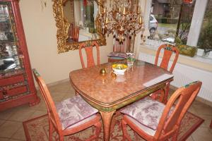 a dining room table with chairs and a mirror at Ferienhaus Magnolia in Wittmund