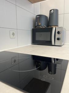 a microwave sitting on top of a counter in a kitchen at Studioapartment/Messewohnung in Cologne