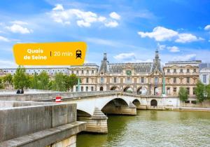 a bridge over a river in front of a large building at 135 Suite Franck - Charmant Studio à Paris in Paris