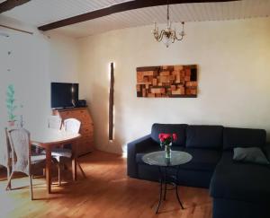 a living room with a blue couch and a table at Ferienwohnung ,,Zur Alten Mühle'' im Storchendorf Rühstädt in Rühstädt