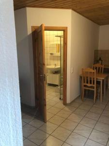 a room with a table and a door to a kitchen at Camping Bockenauer Schweiz in Bockenau