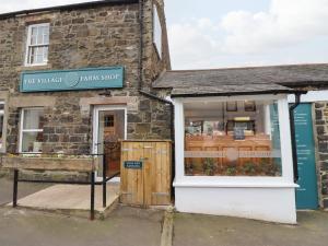 a shop with a sign in the window of a building at 2A Front Street in Alnwick