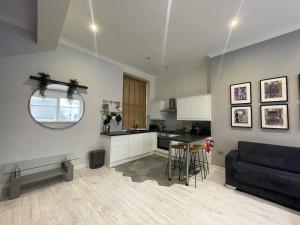 a kitchen and living room with a couch and a table at Fantastic Liverpool City Centre Apartments, Fenwick Street in Liverpool