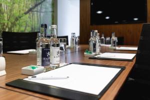 a long wooden table with bottles of wine on it at Best Western Mornington Hotel Hyde Park in London