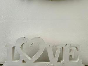 a white sign with a heart on a white wall at In campagna in Besozzo