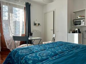 a bedroom with a bed and a table and a window at In campagna in Besozzo