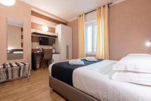a hotel room with a large bed and a desk at La Loggia de' Banchi in La Spezia