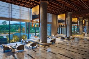 a lobby of a hotel with couches and chairs at Hyatt Regency Dehradun Resort and Spa in Dehradun