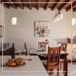 a kitchen with a table with bread and wine glasses at Melissothea Stone Suites in Mesana +45 photos
