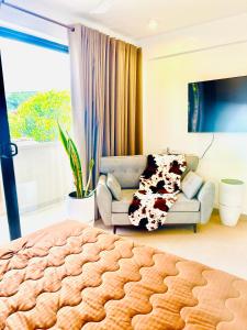a living room with a bed and a couch at sea esta in Mount Lavinia