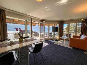 a hotel room with a view of a living room at Seehotel Riviera at Lake Lucerne in Gersau