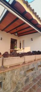 a building with a bunch of plants on a wall at CAL LLOP in Sant Cugat de Sesgarrigues