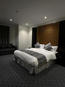a bedroom with a large bed with a large headboard at Art Suite in Riyadh +12 photos