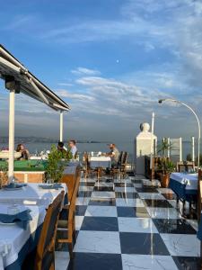 a restaurant with tables and chairs on a roof at Villa Sofia in Istanbul