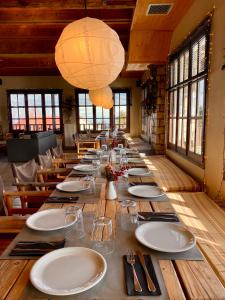 a long table in a restaurant with plates and glasses at Σκίουρος in Neráïda