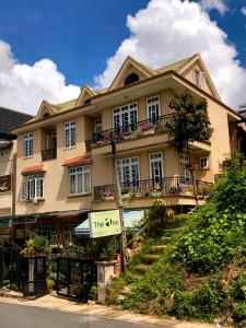 a large house with a sign that reads time zone at The One Home Đà Lạt in Da Lat