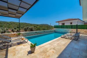a villa with a swimming pool with a view at VILLA LIZYA in Kaş
