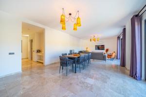 a dining room and living room with a table and chairs at VILLA LIZYA in Kaş