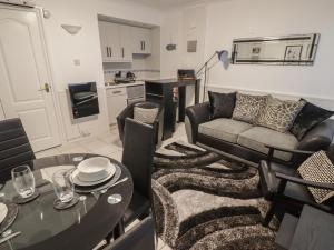 a living room with a couch and a table at Flat 7 in Tenby