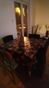 a table with a quilt on it in a room at Stan Ledine 65m2 in Novi Beograd +8 photos
