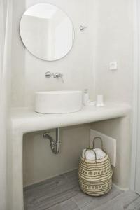 a white bathroom with a sink and a mirror at Villa Areti Naxos in Glinado Naxos