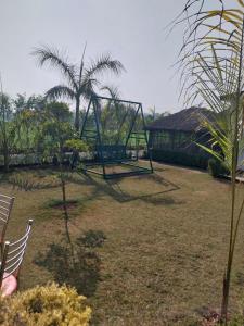 a park with a swing set in a yard at Jim Corbett Tiger Resort in Belparāo