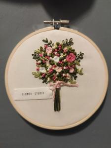 a cross with flowers on a embroidery hoop at Blumen Apartment in Budapest