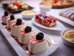 a bunch of desserts on plates on a table at Biker Hotel Al Gallo Forcello in Passo Pramollo
