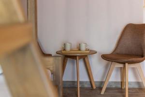 two chairs and a table with two cups on it at Casa Della Zia in Plaka Milou +6 photos