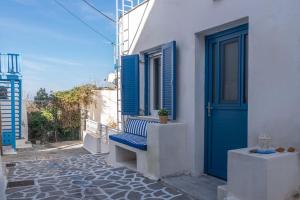 a bench sitting outside of a building with a blue door at Casa Della Zia in Plaka Milou