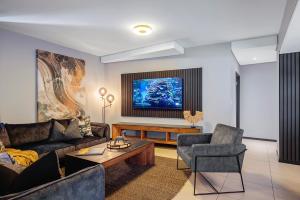 a living room with a couch and a table at CAG The Vantage Rosebank in Johannesburg