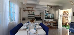 a dining room with a long table and blue chairs at Casa de M&I in General Santos
